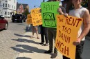Protestors hold up signs including one reading 'The Rent is too damn high' during a rally in Newmarket in September.