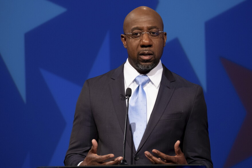 Democratic challenger for U.S. Senate Raphael Warnock speaks during a debate with Republican U.S. Sen. Kelly Loeffler, Sunday, Dec. 6, 2020, in Atlanta. (AP Photo/Ben Gray, Pool)