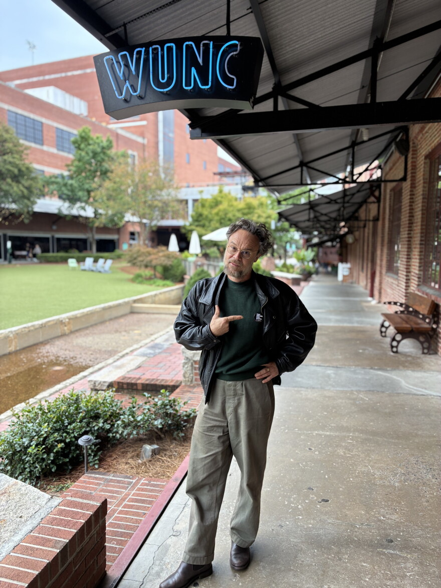 Rodrigo Amarante sports a WUNC News pin outside of WUNC’s studios at the American Tobacco Historic District before performing next door in Bay 7 as part of the Good Moon Festival.