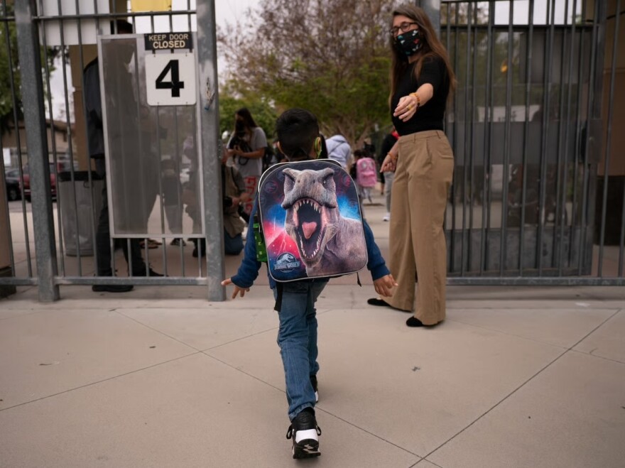 Kindergartener Angel Hernandez leaves after the first day of in-person learning at Maurice Sendak Elementary School in Los Angeles, Tuesday, April 13, 2021.