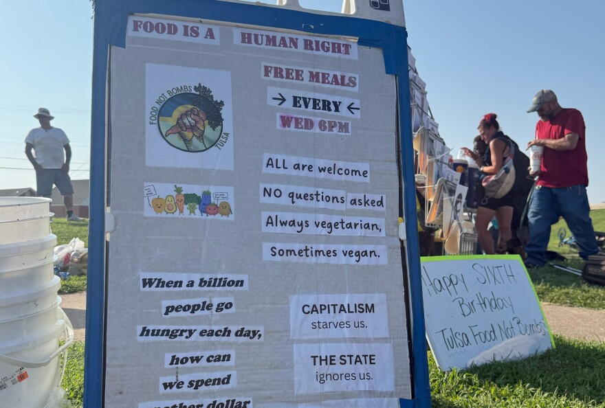 Signs displayed by Tulsa Food Not Bombs volunteers during one of their weekly "sharings."