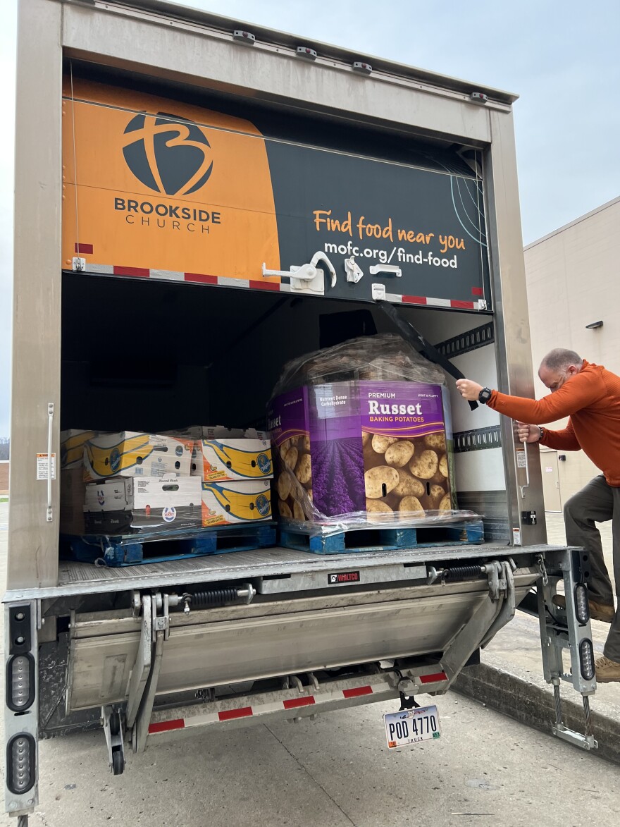 Matt Steinbrook, associate pastor at Brookside Church, rolls shut the back door of the food rescue truck, outside of a Sam's Club warehouse in Chillicothe.