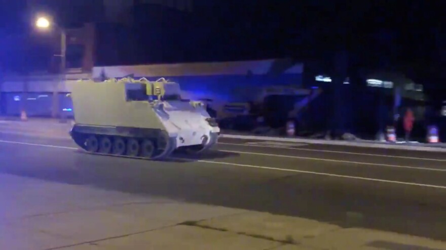 A stolen armored personnel carrier drives through Richmond, Va., on Tuesday.