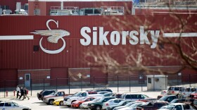 FILE, 2009: Workers walk outside of Black Hawk helicopter maker Sikorsky Aircraft, in Stratford, Conn.