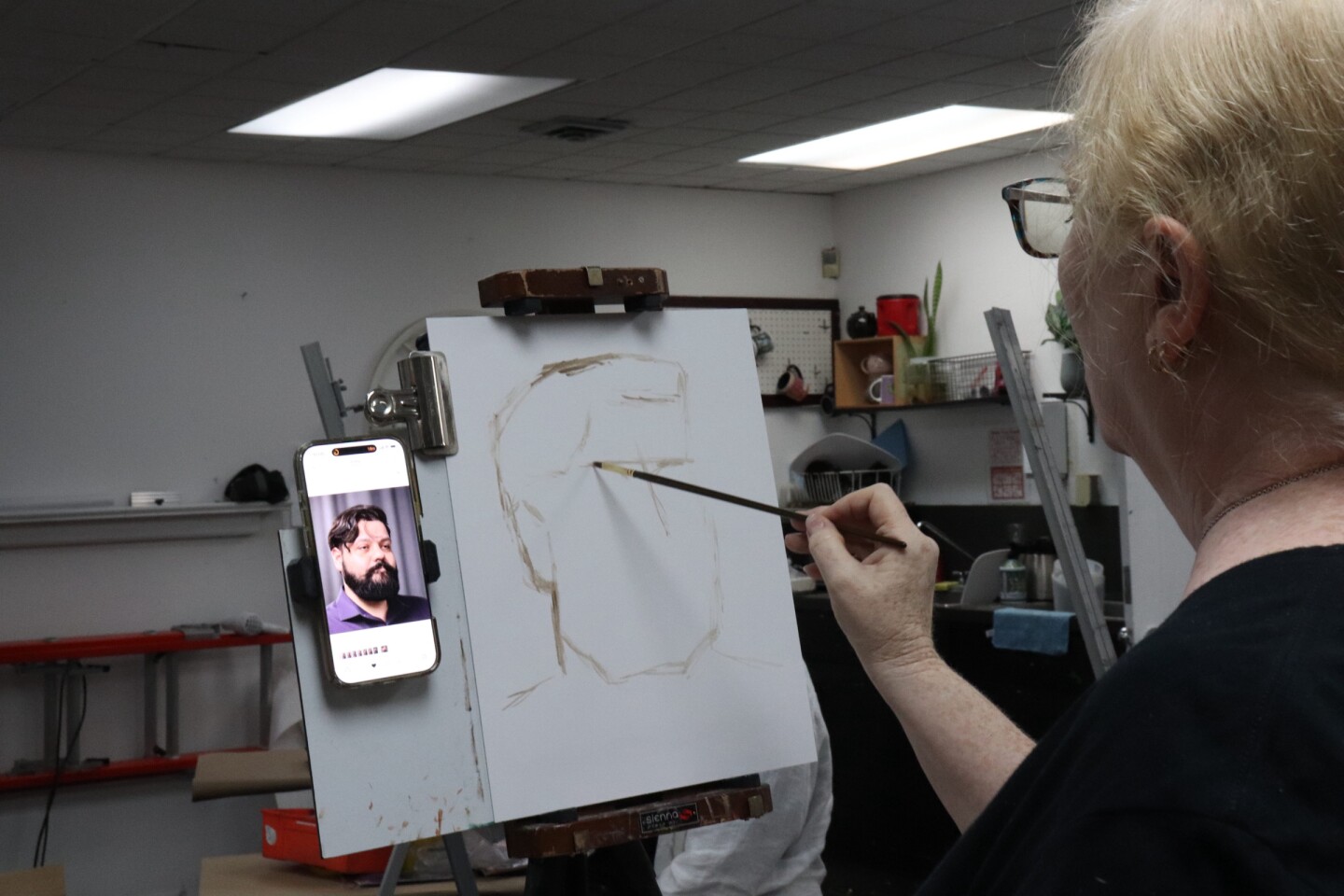 Alison Schuchs sketches her painting of Derek Galvan during a June 24 session at the Art Center of Corpus Christi. Schuchs is a featured artist for the exhibit "Portraitures: Four Perspectives" at the Beeville Art Museum.