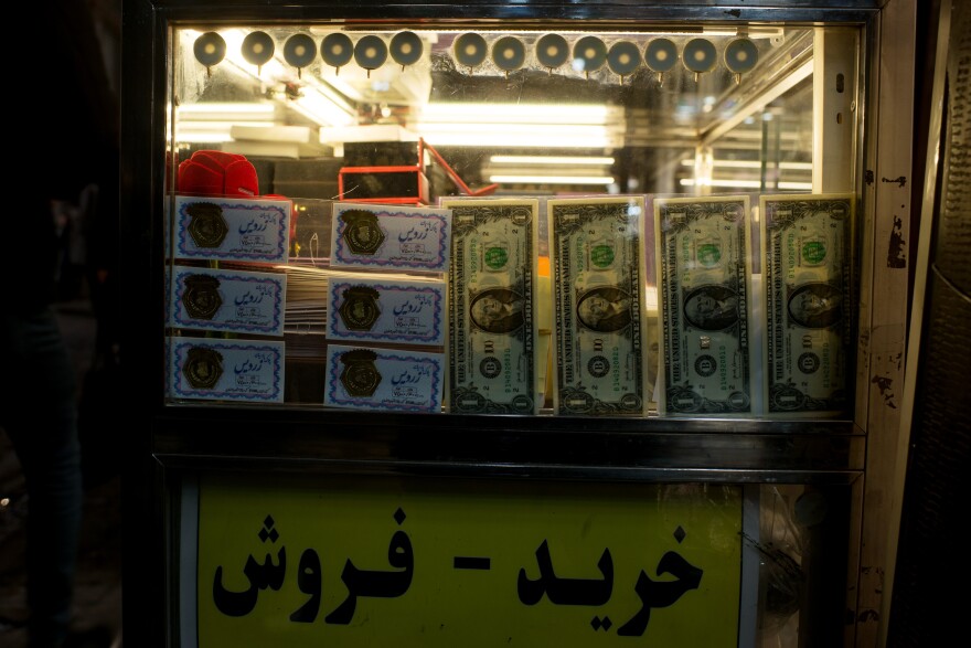 At a small gold and currency trader at the Grand Bazaar in Tehran, the Farsi sign reads: "Buying — Selling."