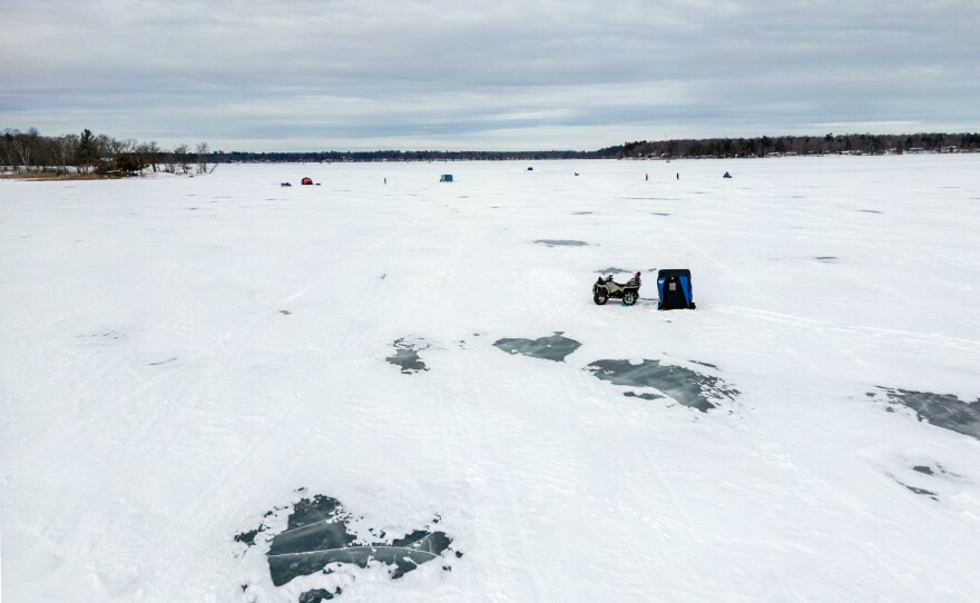 An ATV and an ice fishing house on Lake Minnewawa in McGregor.