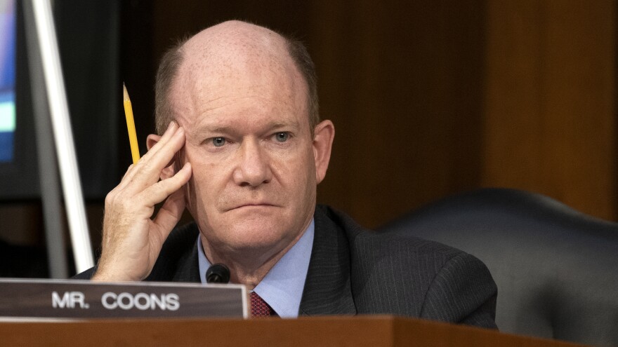 Sen. Chris Coons, D-Del., looks on as Supreme Court nominee Judge Amy Coney Barrett testifies before the Senate Judiciary Committee on the third day of her confirmation hearings.