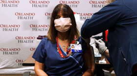 A nurse at Orlando Health receives the first dose of a coronavirus vaccine. Photo courtesy of Orlando Health.