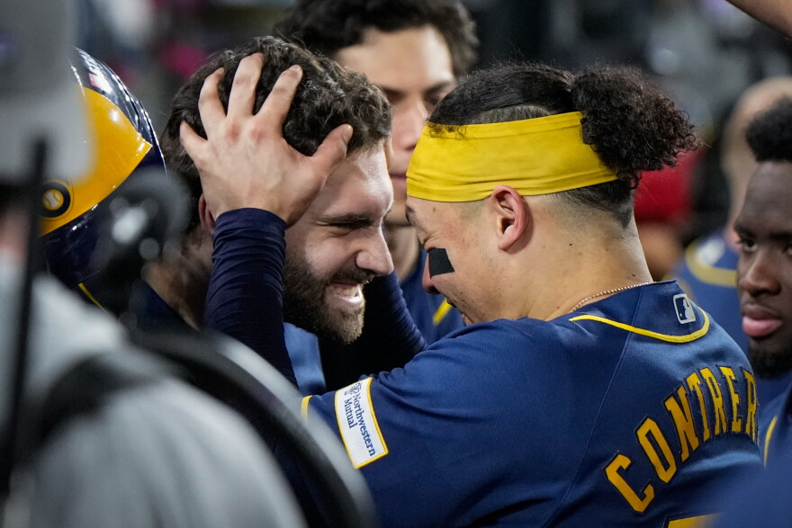 Milwaukee Brewers center fielder Garrett Mitchell celebrates his solo home run with catcher William Contreras in the dugout during the sixth inning of Game 4 of baseball's National League Championship Series between the Milwaukee Brewers and the Los Angeles Dodgers, Thursday, Oct. 15, 2026, in Los Angeles. (AP Photo/Ashley Landis)