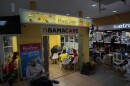 People sit around a table in a yellow building inside a mall.