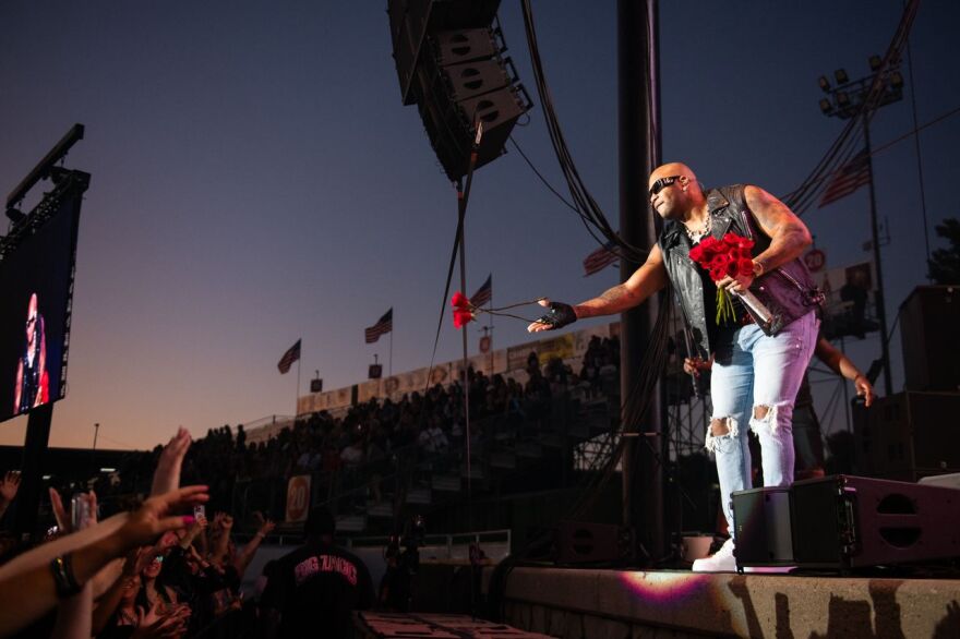 Flo Rida passes out roses to fans during his performance at the 2025 Mid-State Fair.