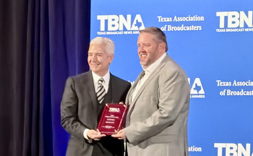 KETR's Jerrod Knight (right) accepts an award plaque from Texas Association of Broadcasters president Oscar Rodriguez (left) at the Texas Broadcast News Awards banquet and ceremony on April 11, 2026 at the Westin Austin at the Domain.