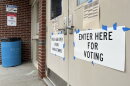 Signs outside a polling place in Keene, N.H., read: "POLLS ARE OPEN FROM 8:00 AM-7:00PM" and "ENTER HERE FOR VOTING."
