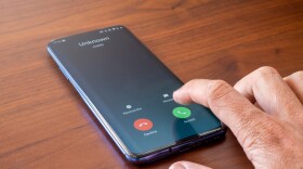 Phone screen shows unknown number calling