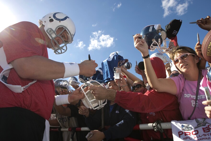 Indianapolis Colts quarterback Payton Manning signs autographs after the AFC Pro Bowl teams practice at Kapolei High School Wednesday, Jan. 26, 2011 in Honolulu. (AP Photo/Eugene Tanner)