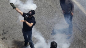 Earlier today (June 28, 2011) in Athens, a demonstrator threw a tear gas grenade back toward police.