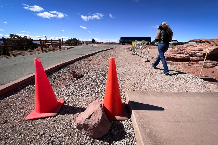 Visitors walk past part of a construction project at Canyonlands National Park in southeast Utah, March 14, 2025. With small budgets and exploding visitation, parks often can't afford to tackle everything it takes to maintain their roads, trails and other infrastructure.