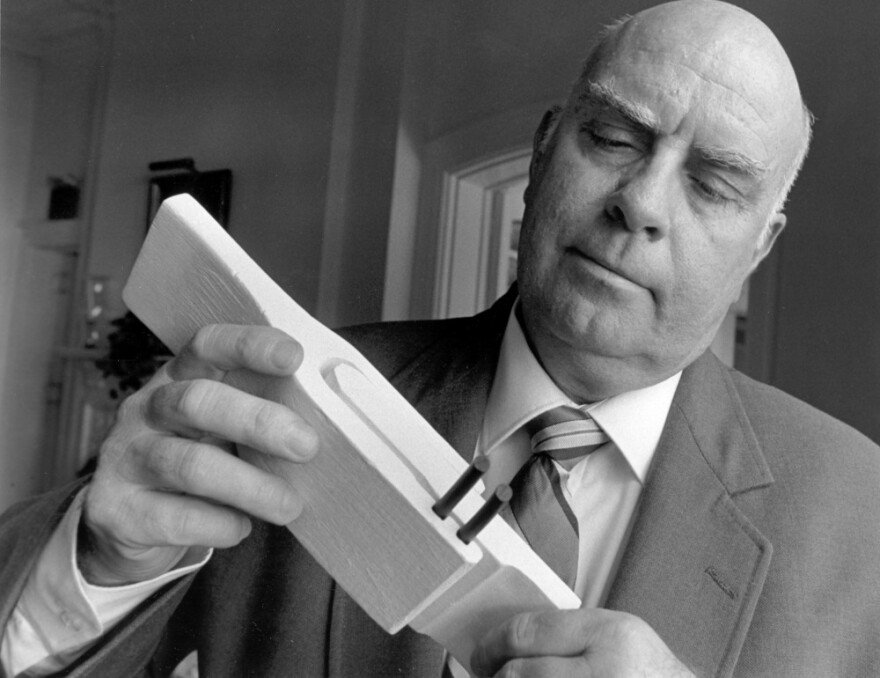 Engineer Roger Boisjoly examines a model of the O-Rings, used to bring the Space Shuttle into orbit, at a meeting of senior executives and academic representatives in Rye, New York in Sept. 1991.