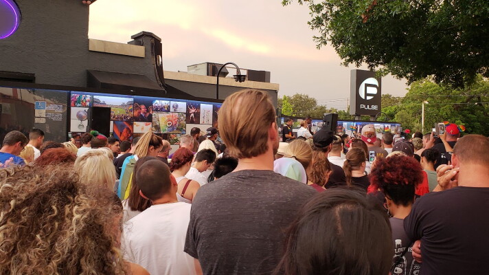 Hundreds gather to grieve on June 12, 2018, outside of the Pulse Nightclub. Ten years after the Pulse Nightclub shooting, the community remains changed both in ways of pain and grief, but also in embracing communities from around the region, experts say.