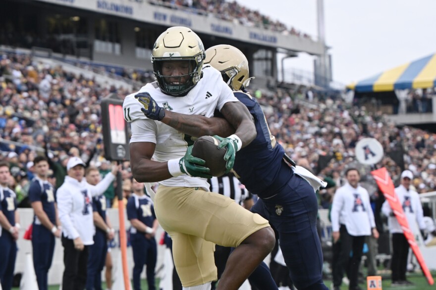 South Florida wide receiver Keshaun Singleton (11) catches a pass for a touchdown in front of Navy cornerback Justin Ross (17) during the first half Saturday, Nov .15, 2025, in Annapolis, Md.