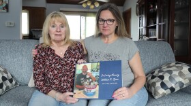 Boni Speer, left, and her daughter, Tracy Balhan, hold a photo of Bill Speer, Tracy’s father, in Aurora, Ill., on Friday, March 14, 2025.