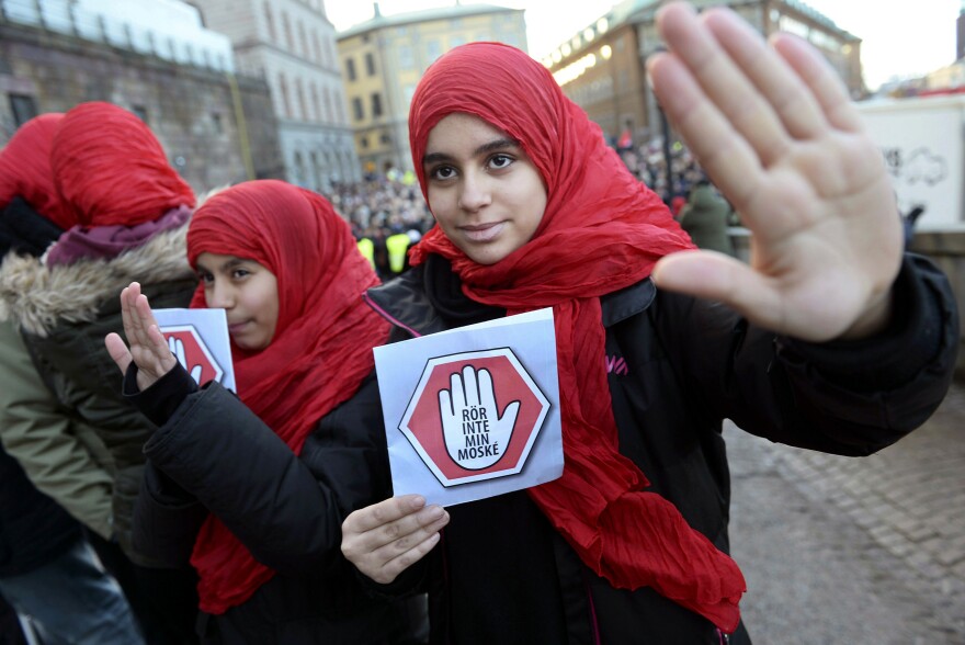 Two young girls carry leaflets reading "Don't touch my mosque" as they participate in a demonstration at the Parliament House in Stockholm last month.