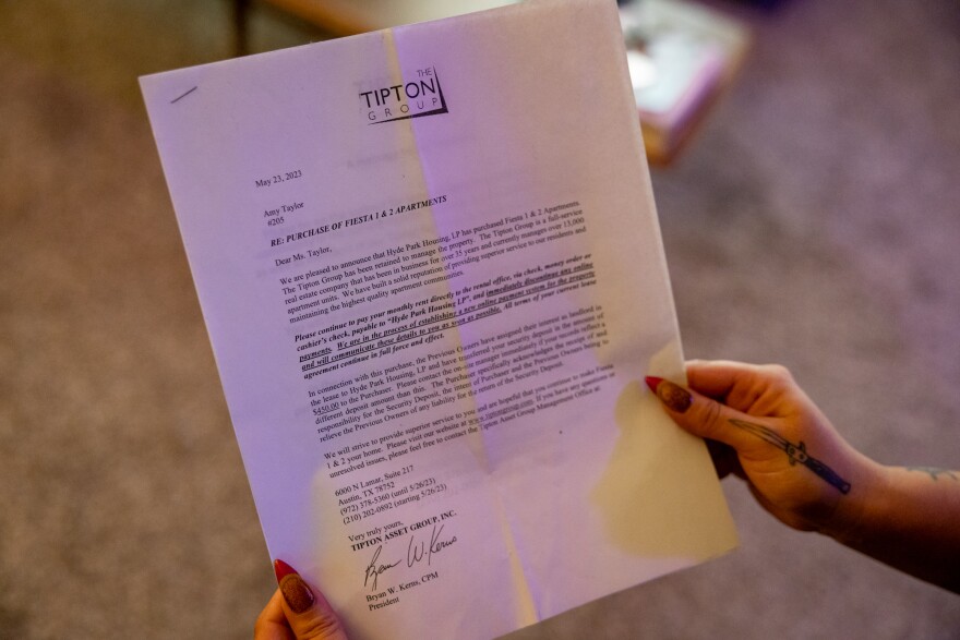 Hands with long nails hold a letter with Tipton Group letterhead