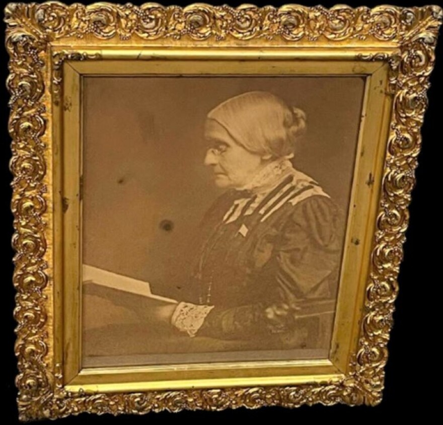 A gold framed portrait of Susan B. Anthony