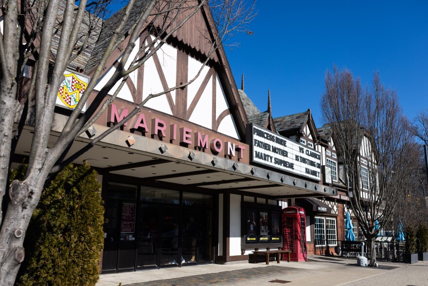 The marquee of a movie theater which is built in the Tudor style.