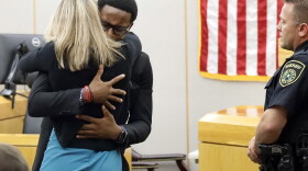 Botham Jean's younger brother Brandt Jean hugs convicted murderer and former Dallas Police Officer Amber Guyger after delivering his impact statement to her after she was sentenced to 10 years in jail, Wednesday, Oct. 2, 2019, in Dallas. (Tom Fox/The Dallas Morning News via AP, Pool)