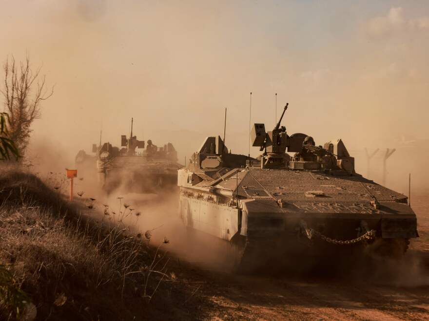 Israeli armored personnel carriers drive on a road at an undisclosed location on the border with the Gaza Strip on Sunday, Oct. 15, 2023. More than one million people have been displaced in the Gaza Strip in the last week, the UN said, after a week of Israeli bombardment and warnings about a ground attack against Hamas commanders.