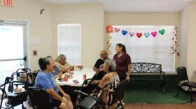 Residents of the Olivares Senior Community talk with the building's assistant manager Joann Olveda after electricity was restored on Aug. 30, 2026.