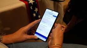 A supporter follows election voting results during an election night watch party for Sen. Bill Cassidy, R-La., Saturday, May 16, 2026, in Baton Rouge, La.