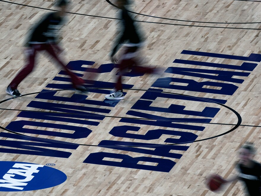 Stanford players, top, and a Utah Valley player warm up before their college basketball game in the first round of the women's NCAA tournament at the Alamodome in San Antonio, in this March 21, 2021, file photo. The NCAA women's basketball tournament used March Madness in marketing and branding this season.