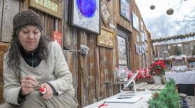 Melinda Petro paints an ordainment at Greenleaf Gourds & Greenhouse in Providence on Monday. The greenhouse is currently hosting the “Sip-N-Shop” event showcasing the work of 23 artists.