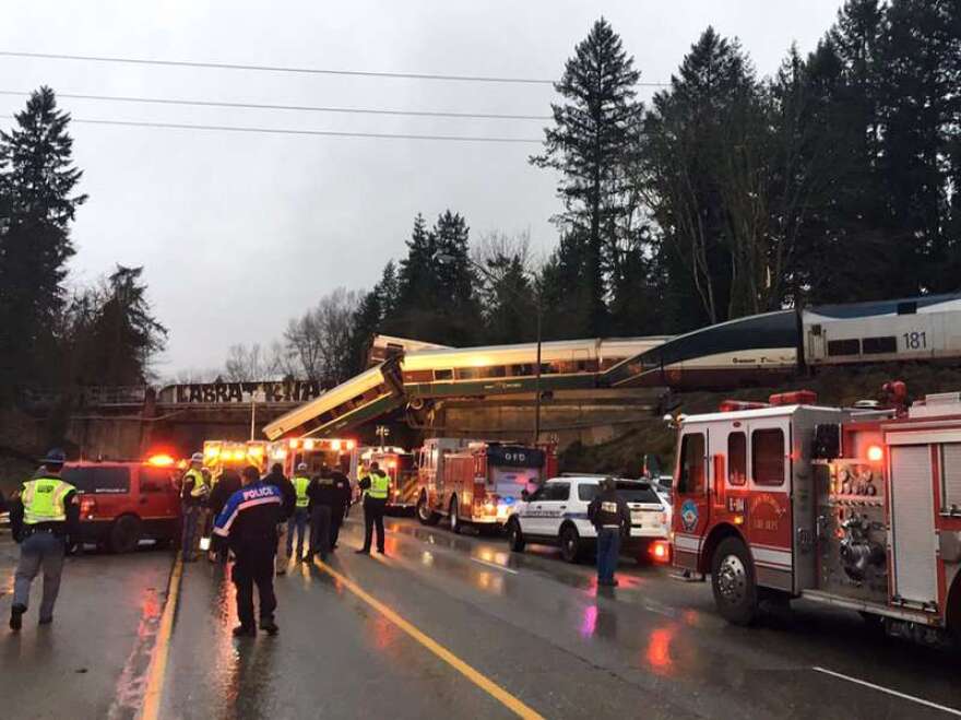 An Amtrak train derailed south of Seattle and fell partly onto Interstate 5, where authorities initially reported "injuries and casualties."/Photo:Washington State Patrol via AP