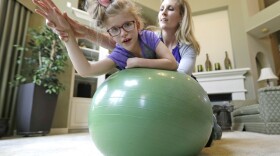 Stacey English, right, works on balance and core strength with her 7-year-old daughter, Addison, in Houston on Friday, June 23, 2017. Texas children with special needs like Addison have lost critical services since the state implemented $350 million in Medicaid cuts to speech, occupational, and physical therapy in December. (David J. Phillip/AP)