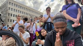 Onlookers share a moment of silence with almost 20 Buddhist monks at the South Carolina Statehouse in Columbia.