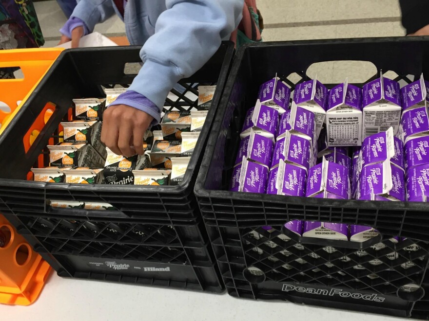 Students at Battle Elementary School in Columbia, Mo. receive items for their school-provided breakfast.