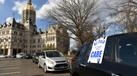 A Caregivers Caravan of union nursing home workers drives slowly around the state Capitol to raise awareness of the critical shortage of PPE, or Personal Protective Equipment, to protect from Covid-19. The caravan, with about 30 cars driven by 1199 SEIU workers, began at the union labor center on Huyshope Avenue in Hartford Thursday afternoon and drove to the Capitol building honking horns and demanding PPE for nursing homes, April 16, 2020.