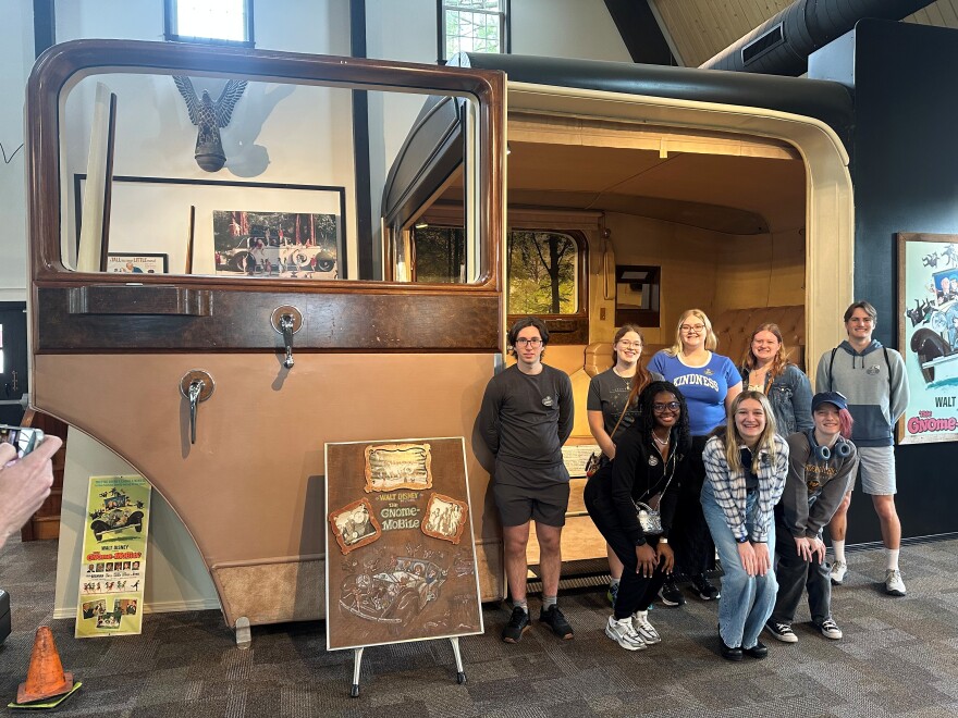 Students in the "Walt's Pilgrimage" course at WMU pose in front of a set-piece from the 1967 Disney film, The Gnome-Mobile, at the Gilmore Car Museum in Barry County. The group will embark on a nine-day journey this summer, visiting Disney-related sites in Illinois, Missouri and California.