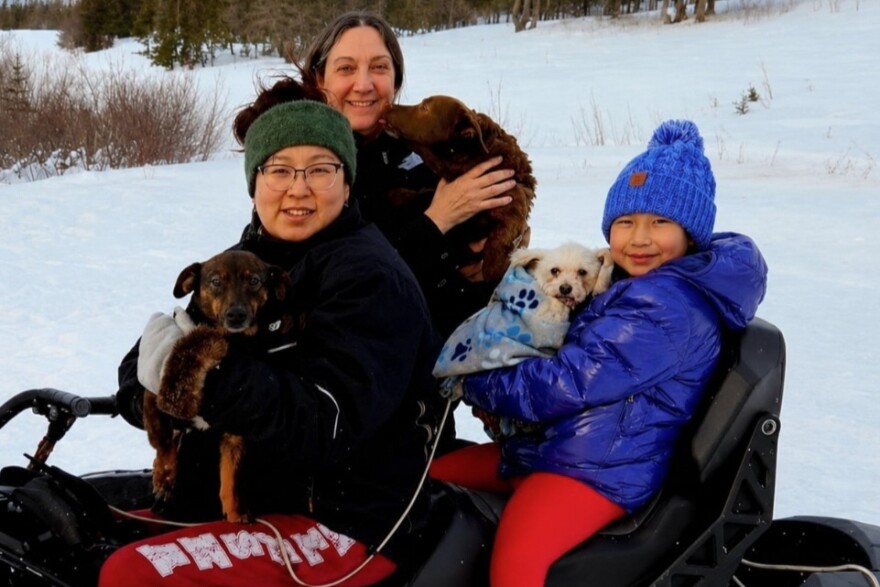 Executive Director of Alaska Native Rural Veterinary Angie Fitch (middle), Koyuk residents and their pets during a veterinary visit.