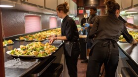 People work inside a kitchen