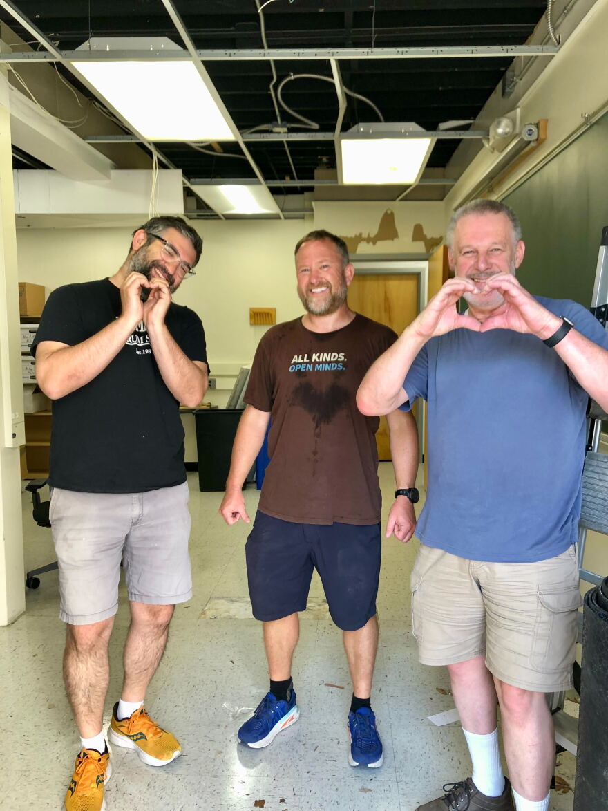 Claus with Chris Prewitt and Classical KC Production Director Sam Wisman, unpacking KCUR's temporary studio at 4747 Troost during a heat wave, July 2026.