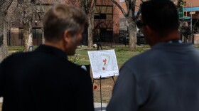 Albuquerque Mayor Tim Keller (left) speaks with a city official (right) before Tuesday's announcement