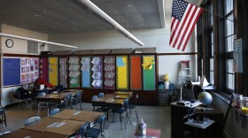 The American flag hangs in a Peck Elementary School classroom Friday, Feb. 1, 2013, in Chicago. Illinois.