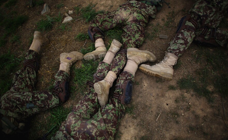 Commandos' legs are jumbled together as they lie prone during a training exercise at Camp Commando.