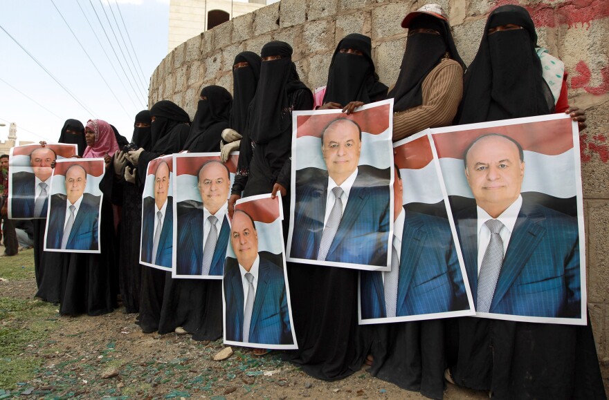 Female demonstrators hold up posters of Yemen's president during an August pro-government demonstration in Sanaa. The rebels took over the presidential palace on Tuesday.