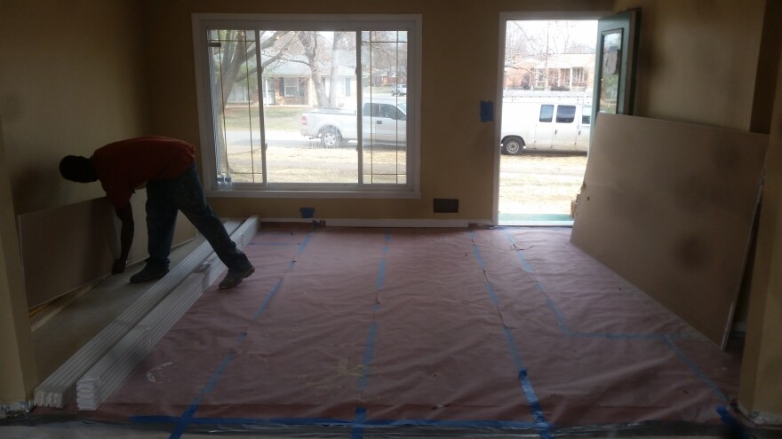 A worker stays busy on a home renovation in Fairdale.